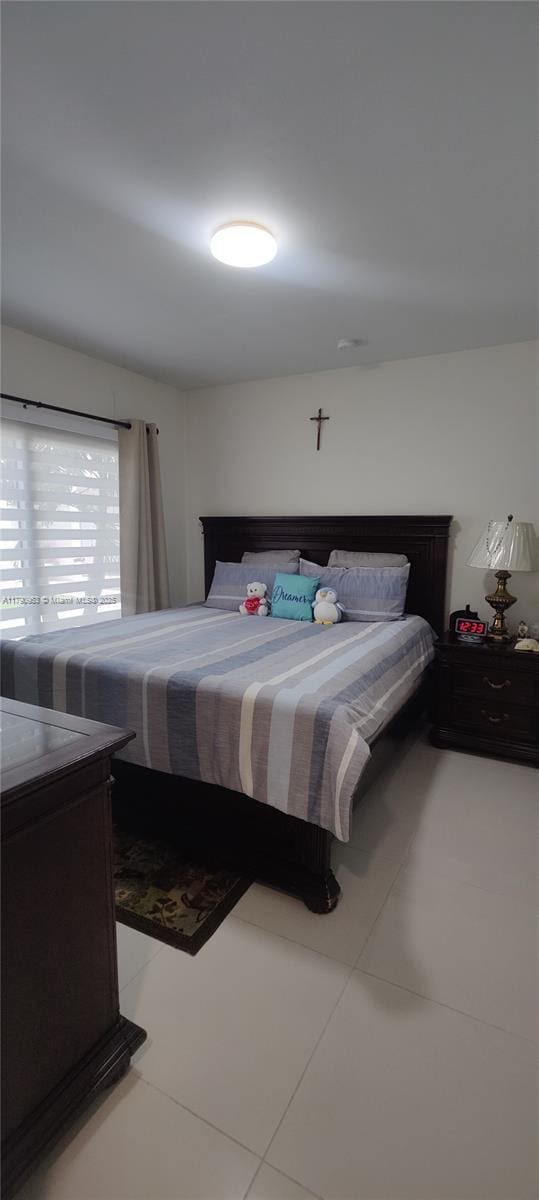 bedroom with light tile patterned floors