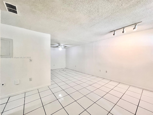 12955 SW 66th Ln Unit 214-2, Miami, FL 33183 - spare room with a ceiling fan, tile patterned flooring, rail lighting, a textured ceiling, and baseboards
