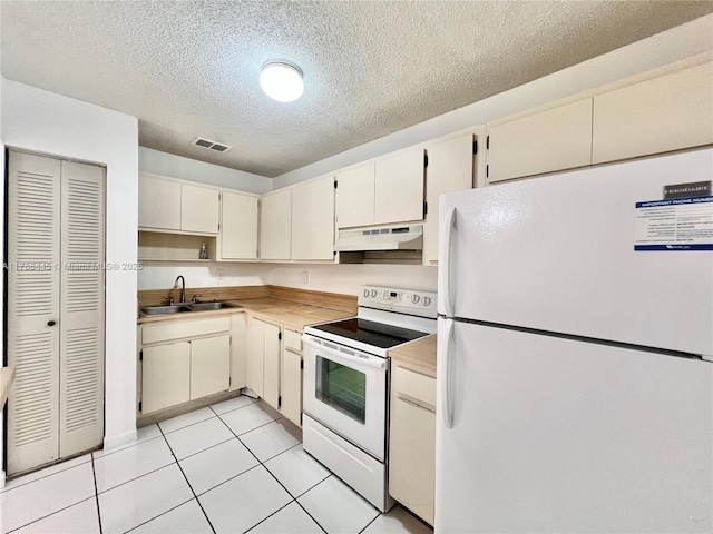12955 SW 66th Ln Unit 214-2, Miami, FL 33183 - kitchen with white appliances, under cabinet range hood, a sink, light countertops, and a textured ceiling