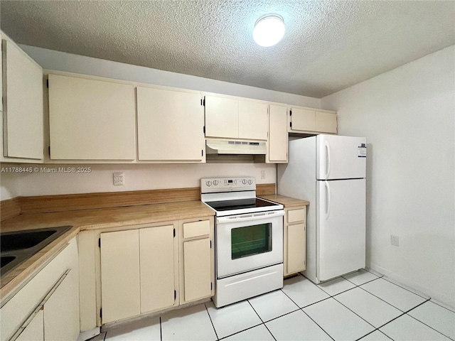 12955 SW 66th Ln Unit 214-2, Miami, FL 33183 - kitchen featuring white appliances, under cabinet range hood, cream cabinetry, a textured ceiling, and light countertops