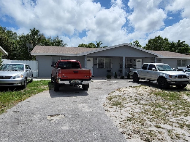 single story home featuring fence and driveway