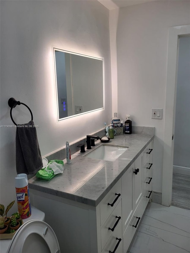 bathroom with vanity and marble finish floor