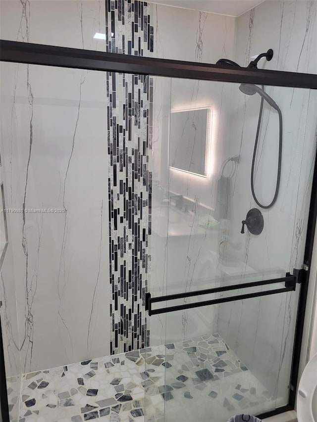 full bathroom with a marble finish shower