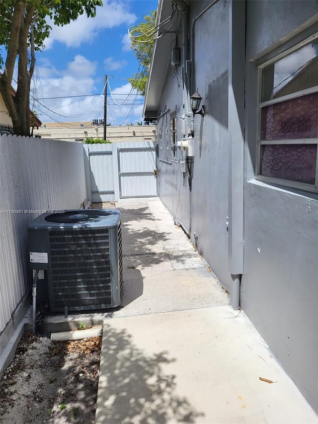 exterior space with central AC, fence, stucco siding, and a patio