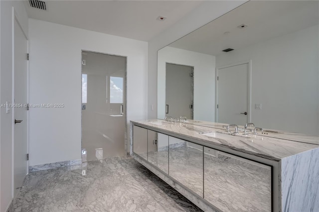 bathroom with double vanity, visible vents, marble finish floor, and a sink