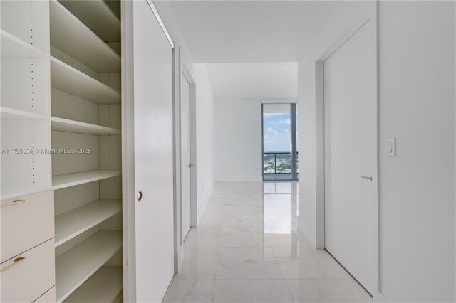 788 NE 23rd St Unit 3102, Miami, FL 33137 - hallway featuring floor to ceiling windows and light marble finish floors