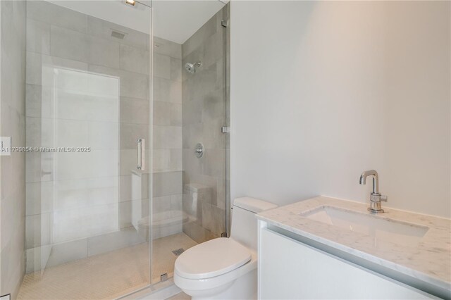 bathroom featuring vanity, toilet, and a shower stall