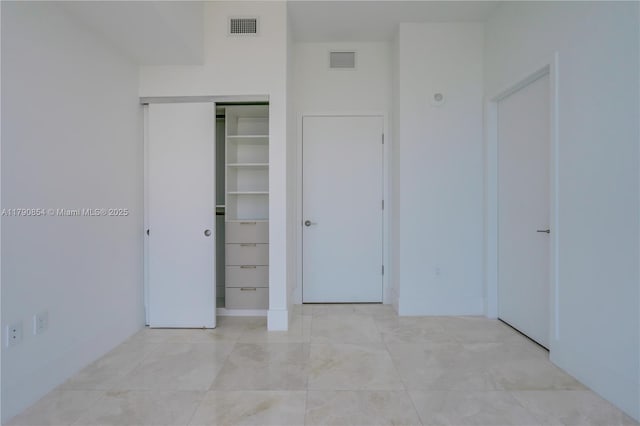 unfurnished bedroom with visible vents and a closet