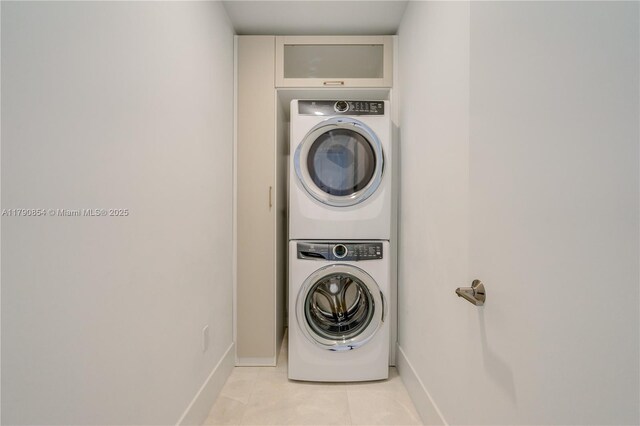 788 NE 23rd St Unit 3102, Miami, FL 33137 - laundry area with estacked washer and dryer, baseboards, and light tile patterned floors