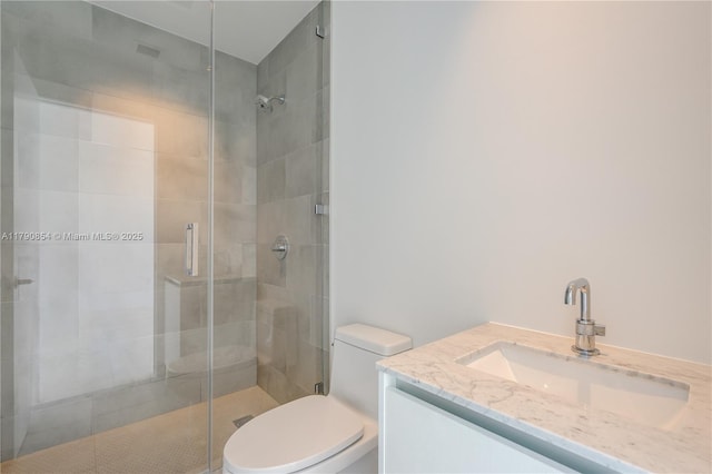 full bath featuring a stall shower, toilet, and vanity