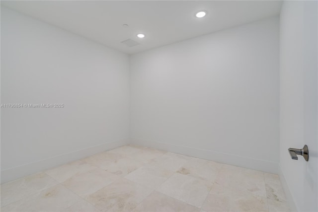 empty room featuring recessed lighting and baseboards