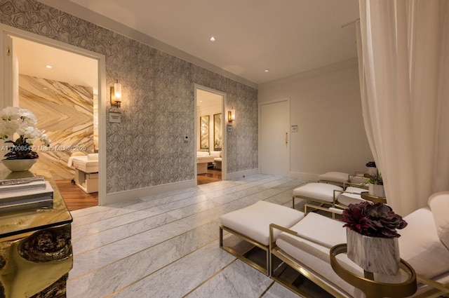 sitting room with baseboards and wallpapered walls