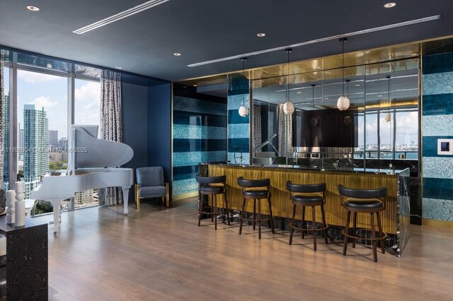 788 NE 23rd St Unit 3102, Miami, FL 33137 - indoor wet bar featuring wood finished floors, expansive windows, and recessed lighting