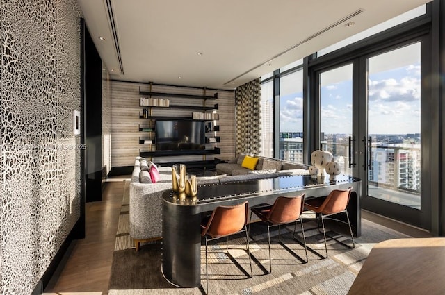 interior space featuring a wealth of natural light, wood finished floors, refrigerator, and wallpapered walls
