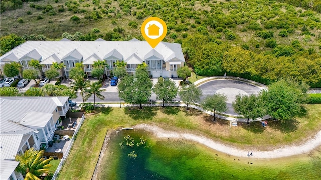 birds eye view of property featuring a water view and a residential view