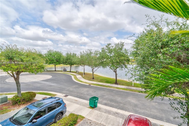 view of street featuring sidewalks and a water view