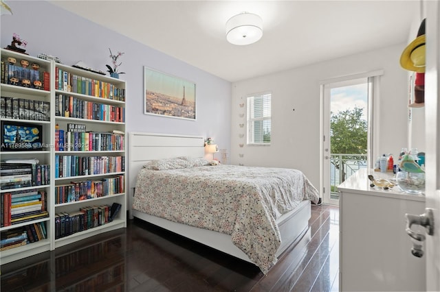 bedroom with dark wood-type flooring and access to exterior