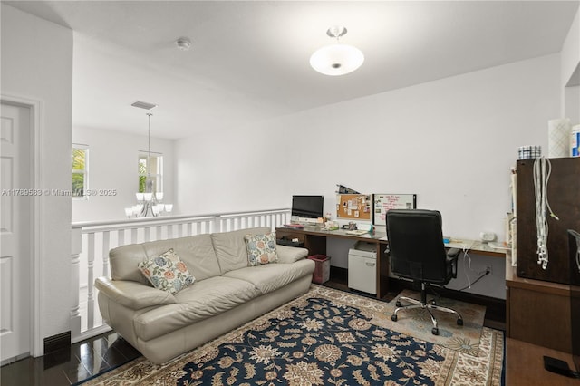 office space with visible vents, wood finished floors, and a notable chandelier