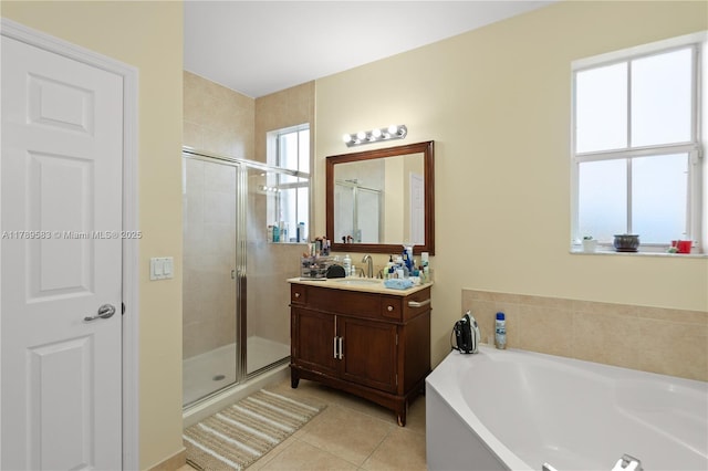 bathroom with tile patterned flooring, a shower stall, and plenty of natural light