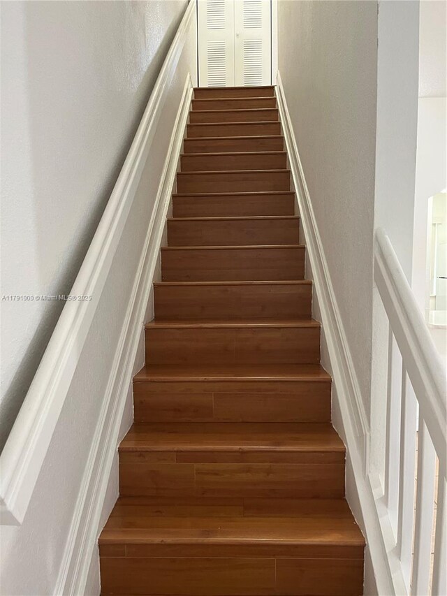 7985 NW 8th St Unit 110A, Miami, FL 33126 - stairway with a textured wall and wood finished floors