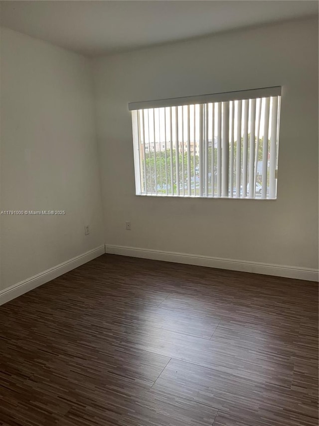 7985 NW 8th St Unit 110A, Miami, FL 33126 - spare room featuring baseboards and dark wood finished floors