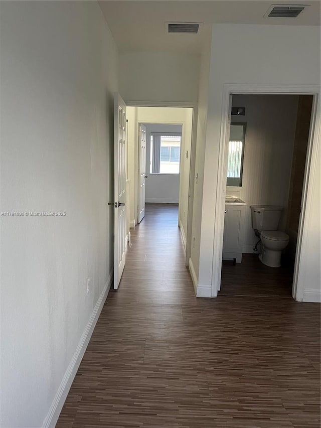 7985 NW 8th St Unit 110A, Miami, FL 33126 - corridor with dark wood finished floors and baseboards