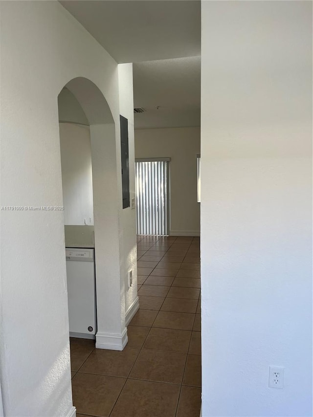 7985 NW 8th St Unit 110A, Miami, FL 33126 - hallway featuring dark tile patterned flooring, arched walkways, and baseboards