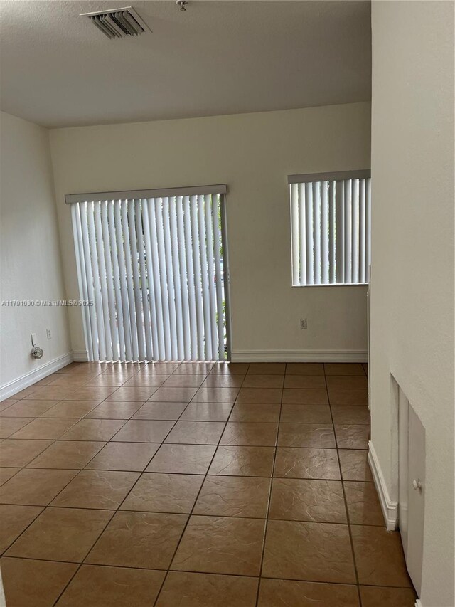 7985 NW 8th St Unit 110A, Miami, FL 33126 - empty room with tile patterned floors and baseboards