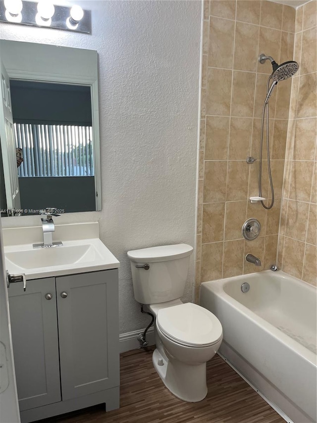 7985 NW 8th St Unit 110A, Miami, FL 33126 - full bathroom with vanity, toilet, wood finished floors, a textured wall, and bathing tub / shower combination