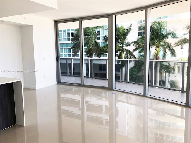 488 NE 18th St Unit 215, Miami, FL 33132 - tiled spare room featuring expansive windows and a healthy amount of sunlight