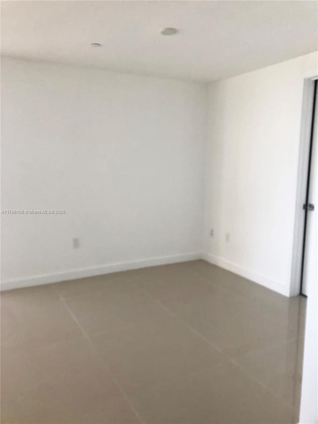 488 NE 18th St Unit 215, Miami, FL 33132 - unfurnished room featuring tile patterned flooring and baseboards
