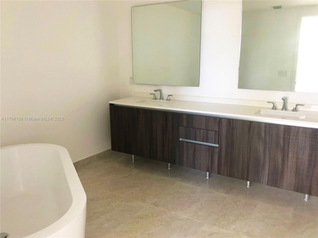 488 NE 18th St Unit 215, Miami, FL 33132 - bathroom with double vanity, a freestanding bath, and a sink