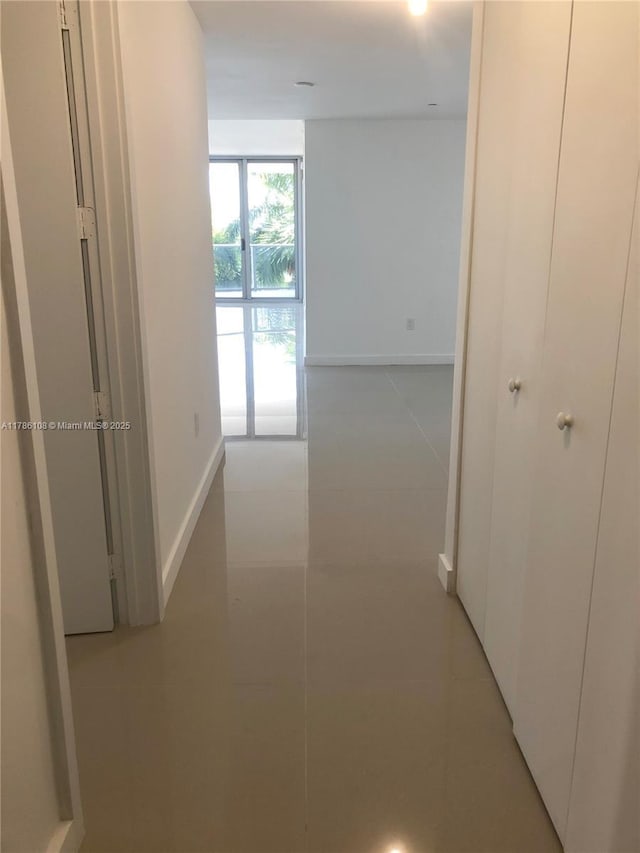 488 NE 18th St Unit 215, Miami, FL 33132 - hallway featuring light tile patterned flooring and baseboards