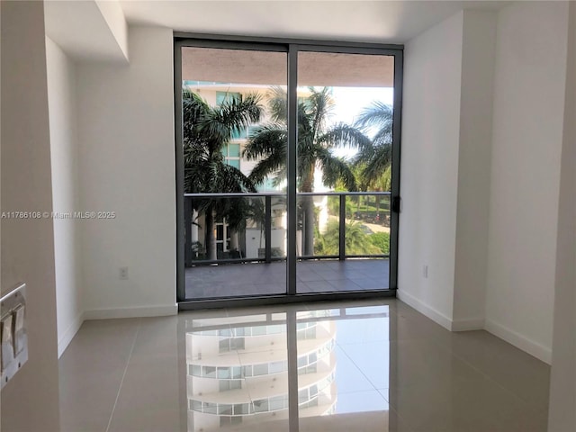 488 NE 18th St Unit 215, Miami, FL 33132 - spare room featuring baseboards, tile patterned floors, and floor to ceiling windows