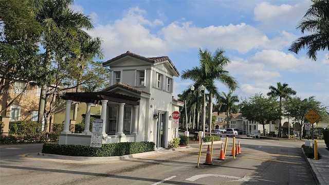 exterior space featuring curbs, street lighting, and traffic signs