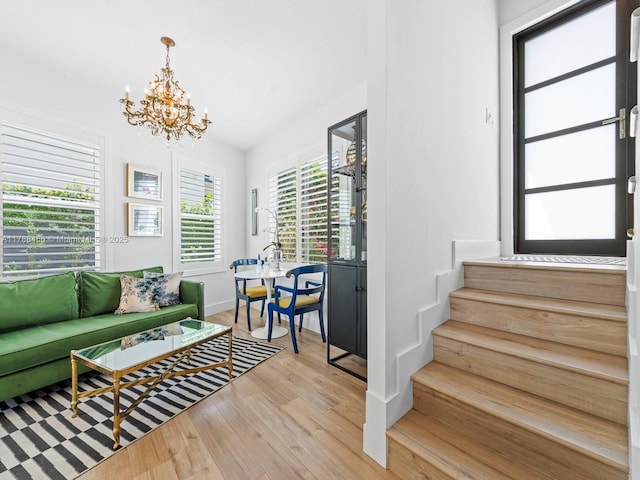 3025 SW 13th St, Miami, FL 33145 - living area with a chandelier, light wood-style floors, stairway, and baseboards