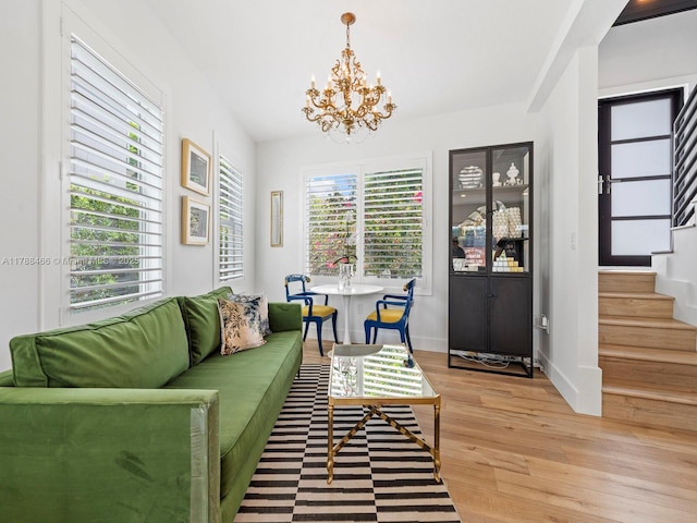 3025 SW 13th St, Miami, FL 33145 - living room featuring light wood-style flooring, a chandelier, stairway, and baseboards