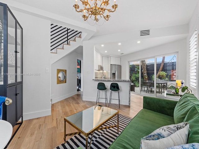 3025 SW 13th St, Miami, FL 33145 - living room with a chandelier, light wood-style flooring, baseboards, recessed lighting, and stairway