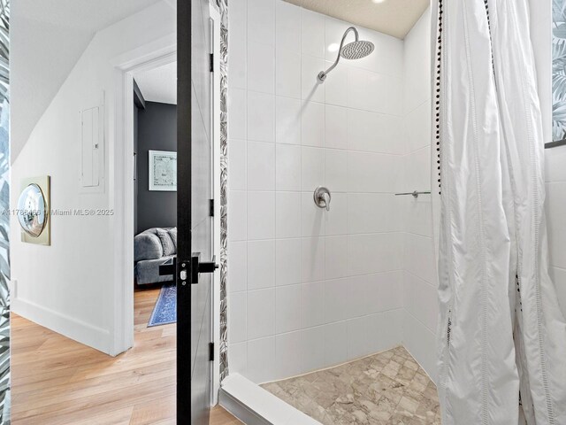3025 SW 13th St, Miami, FL 33145 - bathroom with tiled shower, wood finished floors, and baseboards