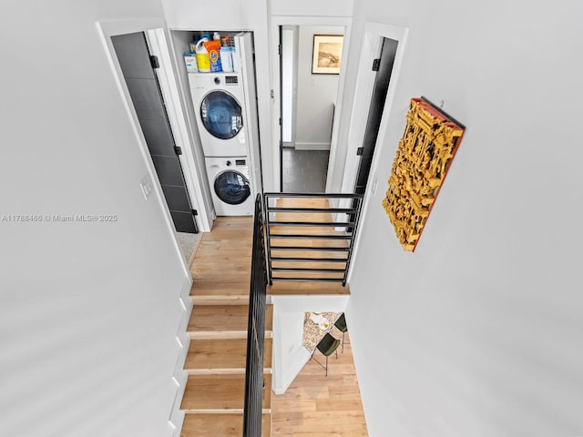 3025 SW 13th St, Miami, FL 33145 - staircase featuring stacked washing machine and dryer and wood finished floors