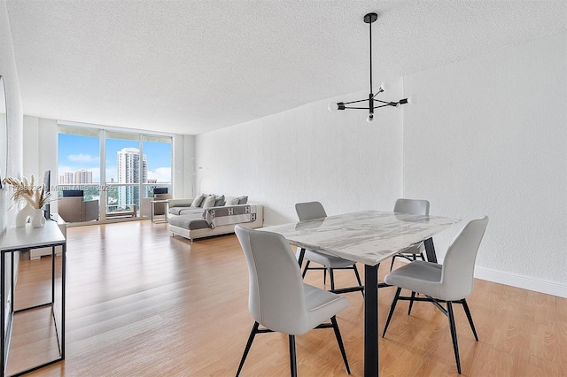 19390 Collins Ave Unit 1501, Sunny Isles Beach, FL 33160 - dining space featuring a textured ceiling, a textured wall, light wood finished floors, wine cooler, and floor to ceiling windows