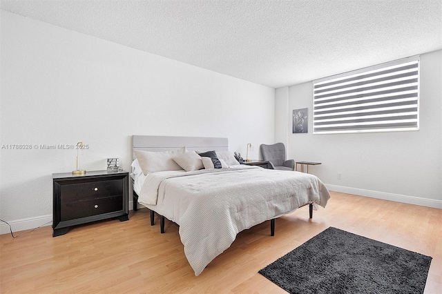 19390 Collins Ave Unit 1501, Sunny Isles Beach, FL 33160 - bedroom with light wood-type flooring and a textured ceiling