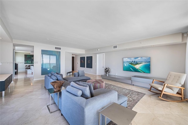 living room featuring marble finish floor and visible vents