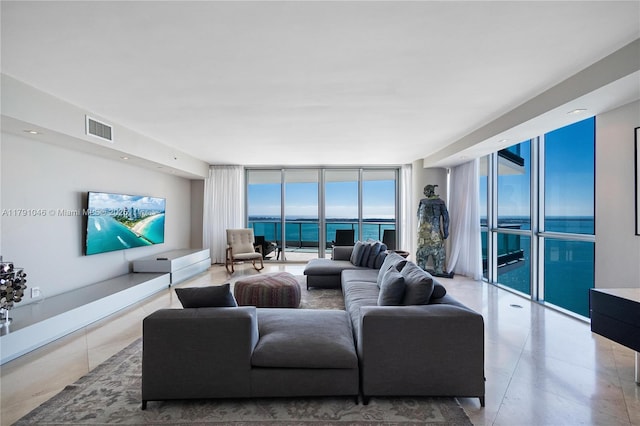 tiled living area featuring visible vents and expansive windows