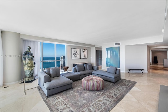 living area featuring baseboards, visible vents, and light tile patterned flooring