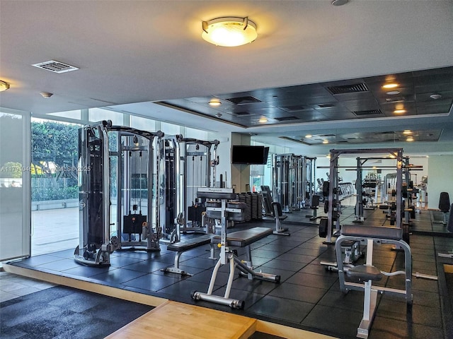 gym featuring a wall of windows and visible vents