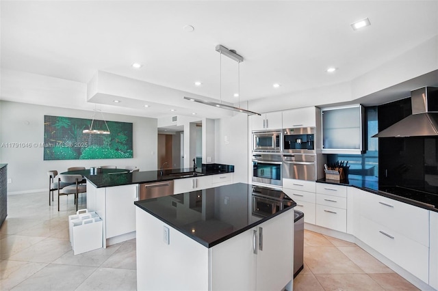 kitchen featuring white cabinets, modern cabinets, dark countertops, and appliances with stainless steel finishes