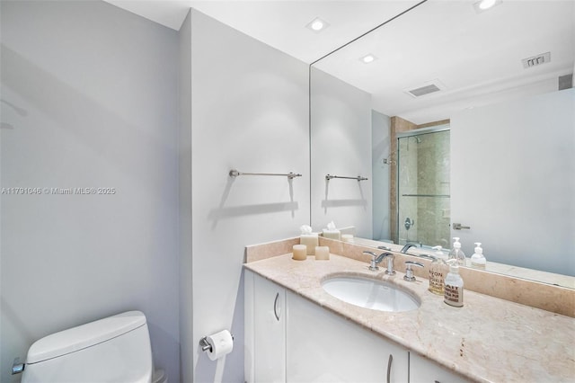 full bath with recessed lighting, a shower stall, vanity, toilet, and visible vents