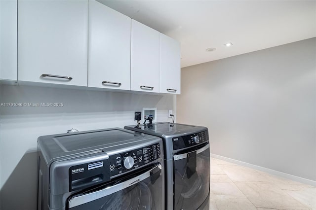 laundry room with separate washer and dryer, cabinet space, recessed lighting, and baseboards