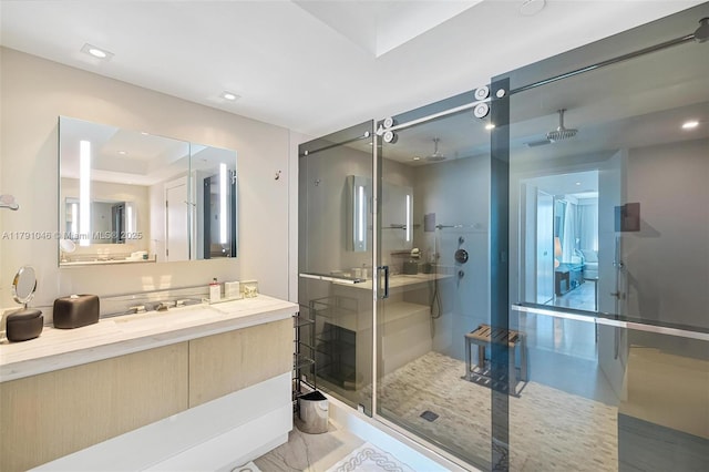 bathroom featuring a shower stall and vanity